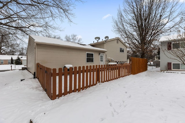 view of snow covered back of property