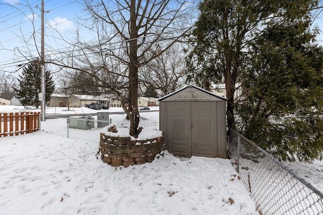 snowy yard with a shed