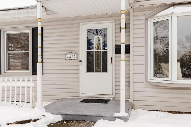 view of snow covered property entrance