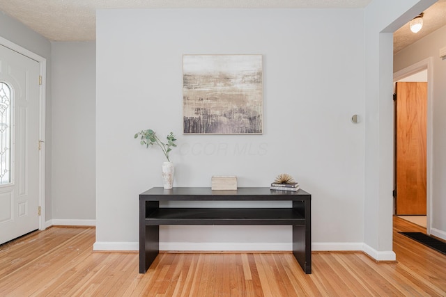 foyer with a textured ceiling and hardwood / wood-style flooring