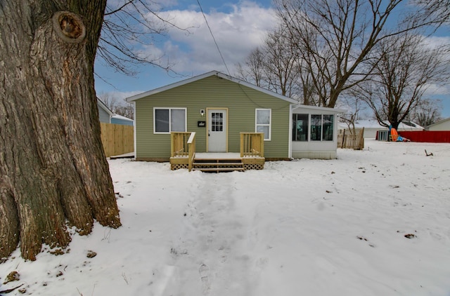 view of front of property with a sunroom and a wooden deck