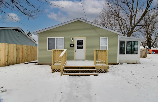 view of front facade with a sunroom and a deck