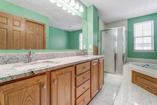 bathroom featuring vanity, a textured ceiling, and independent shower and bath