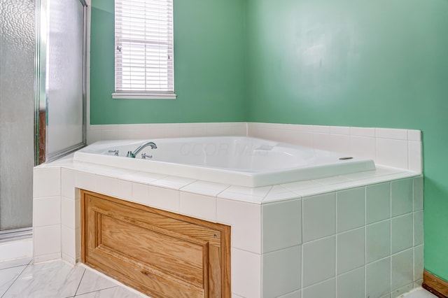 bathroom featuring independent shower and bath