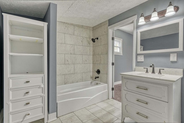 bathroom with a textured ceiling, tile patterned floors, vanity, and tiled shower / bath