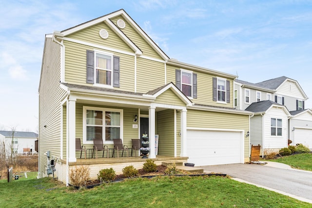 view of front of house with a garage, covered porch, and a front lawn