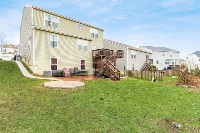 rear view of house featuring a yard, a patio, and a deck