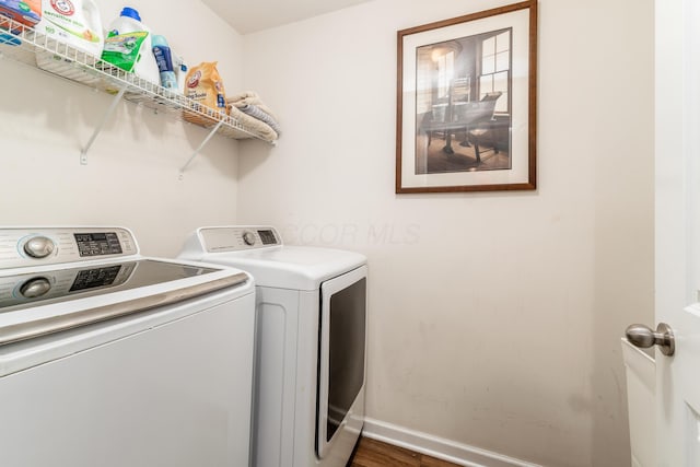 laundry area featuring dark hardwood / wood-style flooring and washer and clothes dryer