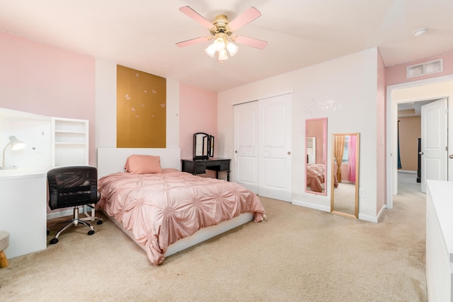 bedroom with ceiling fan, a closet, and light carpet