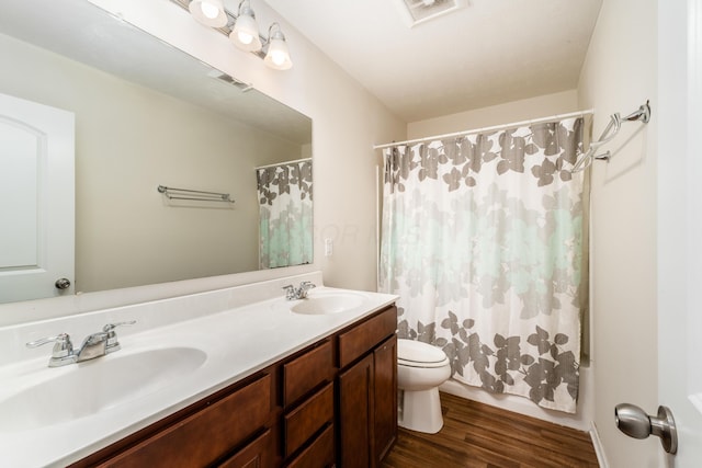 full bathroom featuring wood-type flooring, toilet, shower / tub combo, and vanity