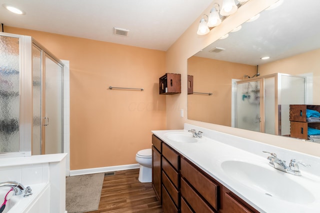 full bathroom with vanity, wood-type flooring, plus walk in shower, and toilet