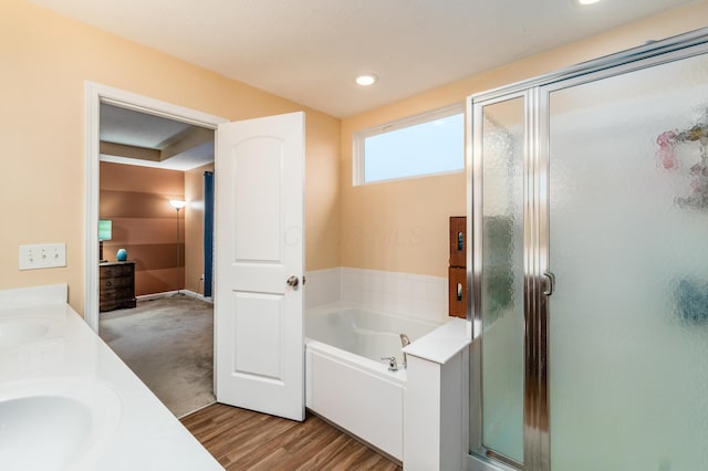 bathroom featuring vanity, separate shower and tub, and hardwood / wood-style floors