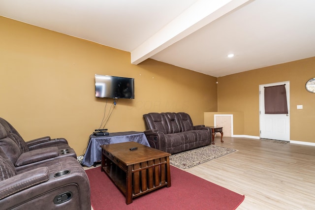 living room with beamed ceiling and wood-type flooring