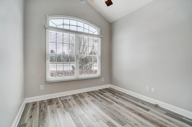 unfurnished room featuring ceiling fan, lofted ceiling, and light wood-type flooring