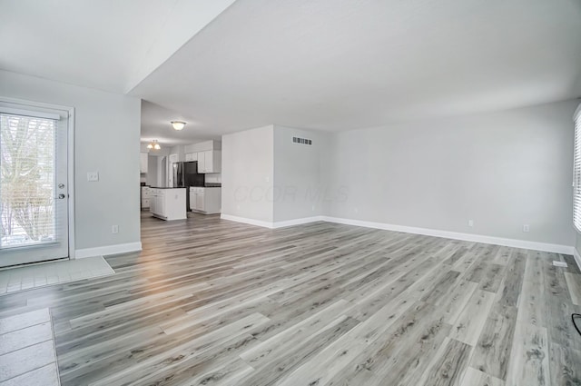 unfurnished living room featuring light wood-type flooring