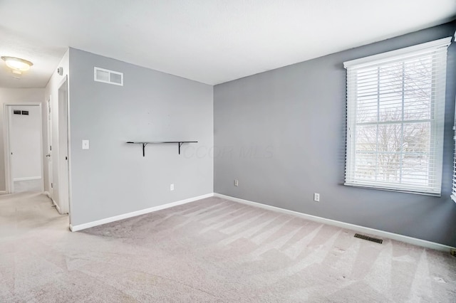 empty room featuring light colored carpet