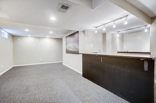 bar with dark colored carpet and rail lighting