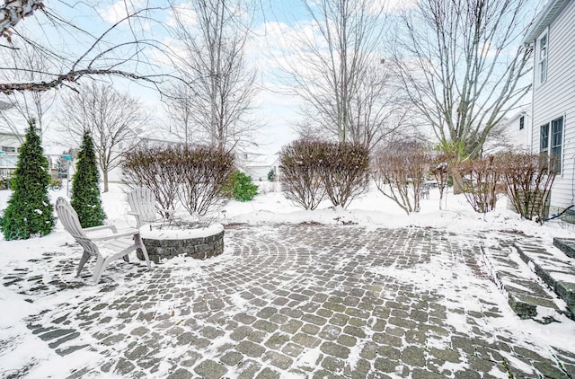 yard layered in snow with an outdoor fire pit