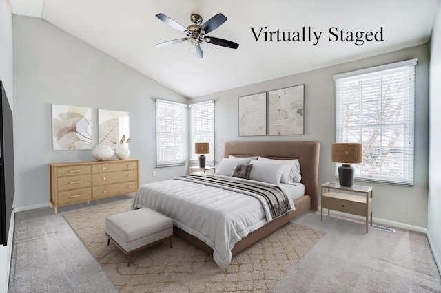 bedroom with ceiling fan, light carpet, and vaulted ceiling