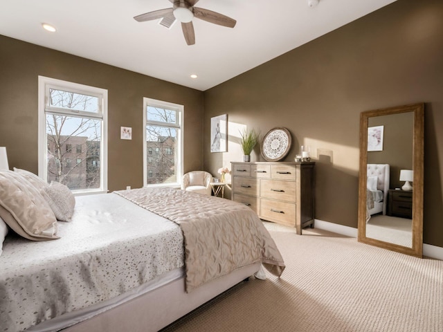 bedroom with ceiling fan and light colored carpet