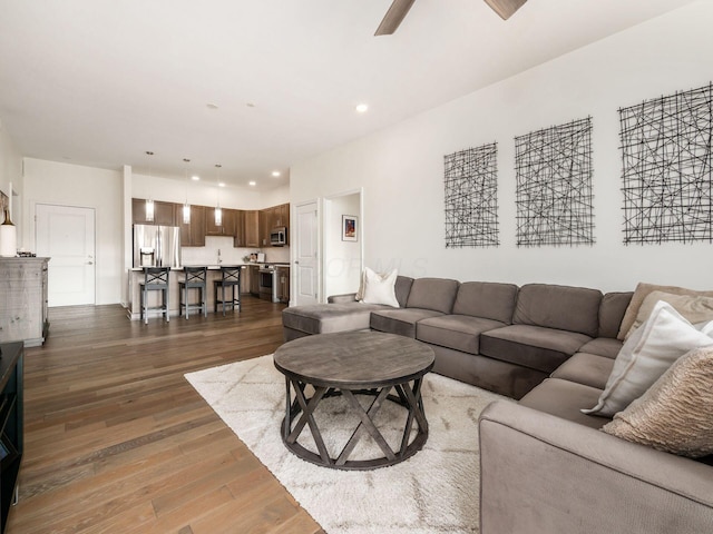 living room with hardwood / wood-style flooring and ceiling fan