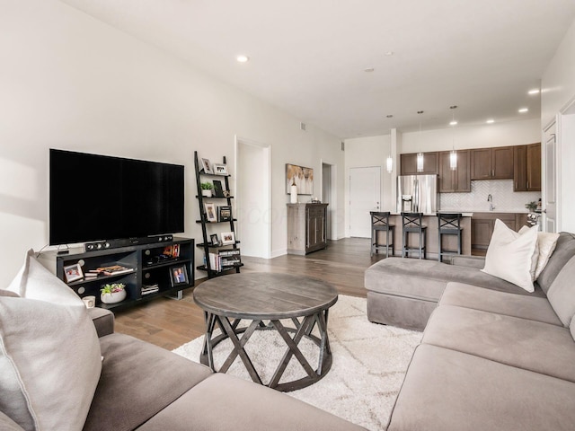 living room featuring light wood-type flooring and sink