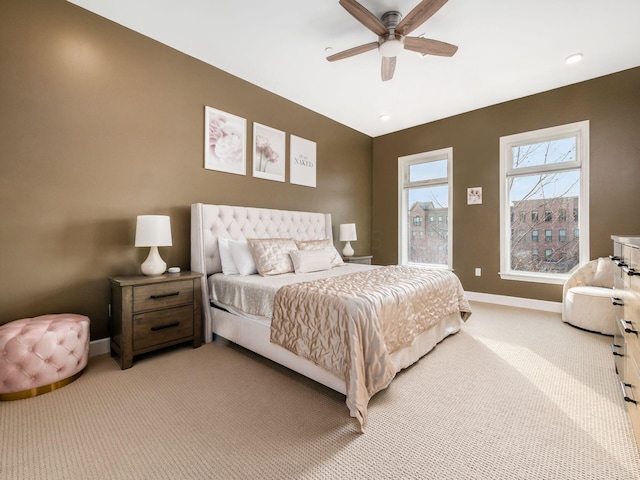 bedroom with ceiling fan and light colored carpet