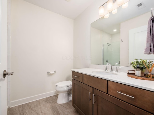 bathroom featuring toilet, walk in shower, and vanity