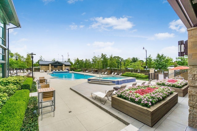 view of pool featuring a patio area and a community hot tub