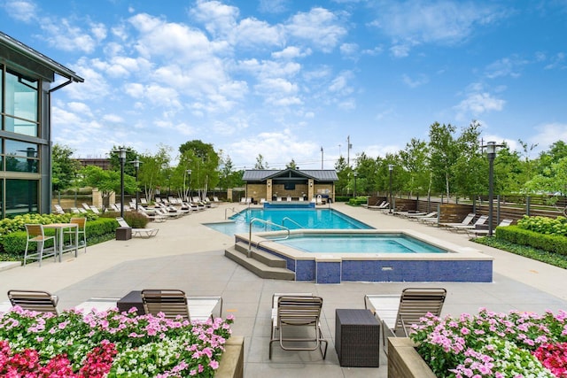 view of pool with a patio area and a community hot tub