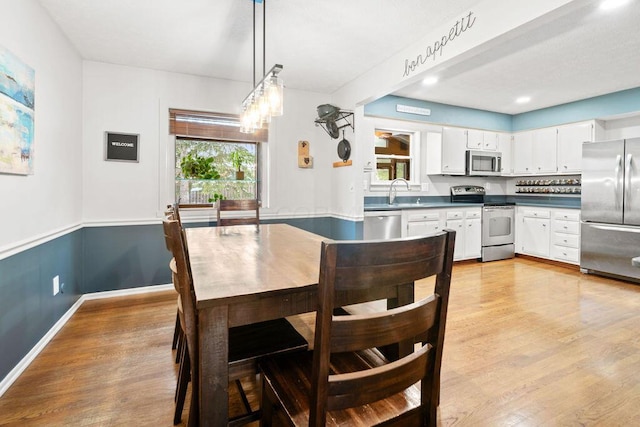 dining area featuring light hardwood / wood-style floors and plenty of natural light