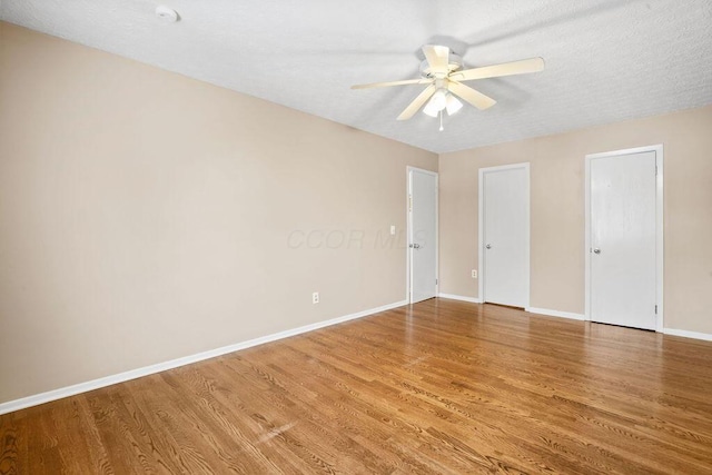 spare room featuring hardwood / wood-style floors, a textured ceiling, and ceiling fan