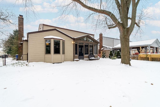 view of snow covered rear of property