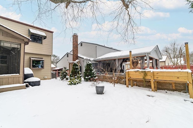 view of snow covered rear of property