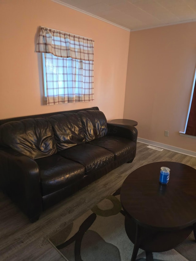 living room with dark hardwood / wood-style flooring and crown molding