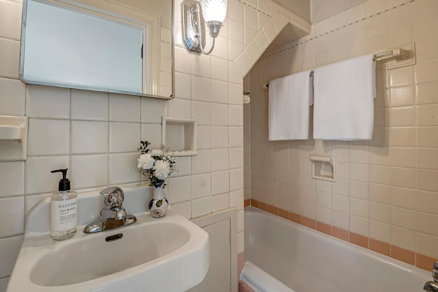 bathroom with sink, tile walls, and backsplash