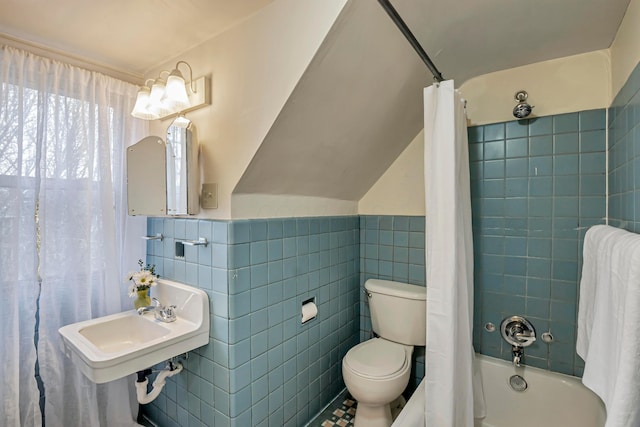 bathroom with toilet, lofted ceiling, tile walls, and shower / bath combo with shower curtain