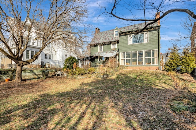 back of house featuring a sunroom