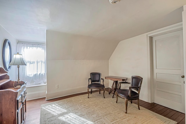 sitting room with vaulted ceiling and light wood-type flooring