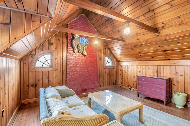 sitting room featuring lofted ceiling with beams, wood-type flooring, and a wealth of natural light