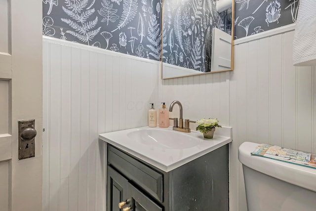 bathroom featuring vanity and toilet