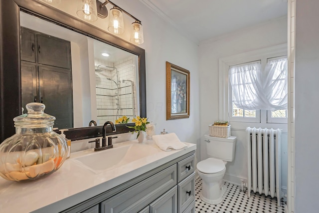 bathroom featuring radiator, tiled shower, vanity, ornamental molding, and toilet