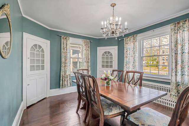 dining space with dark wood-type flooring, ornamental molding, radiator, and a wealth of natural light