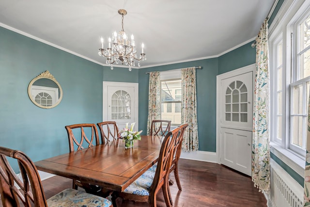 dining space featuring ornamental molding, dark hardwood / wood-style floors, and a chandelier