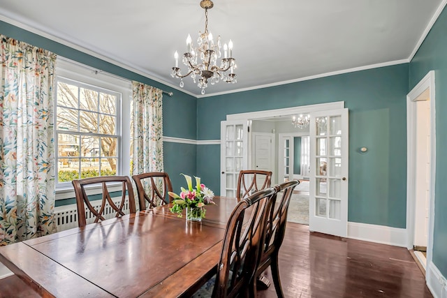 dining area with an inviting chandelier, ornamental molding, and dark wood-type flooring