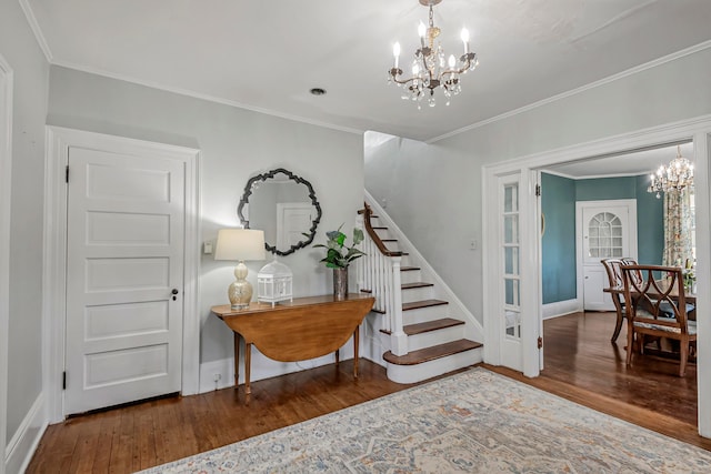 stairway featuring crown molding, a chandelier, and hardwood / wood-style floors