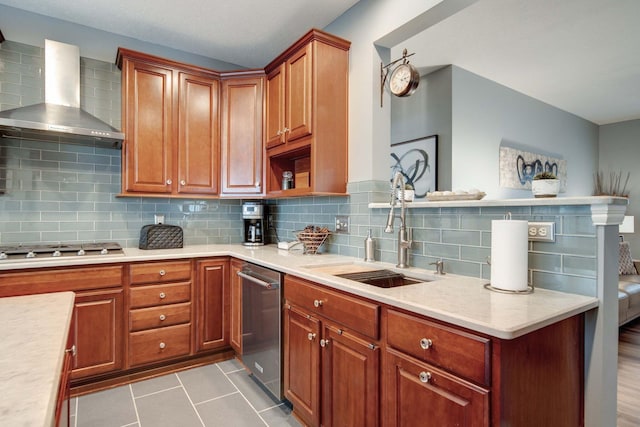 kitchen with wall chimney exhaust hood, sink, light tile patterned floors, appliances with stainless steel finishes, and backsplash