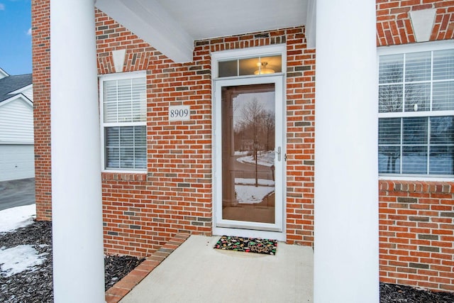 view of snow covered property entrance