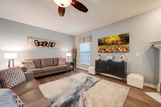 living room with wood-type flooring and ceiling fan