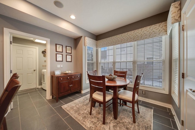 tiled dining room featuring washer / dryer